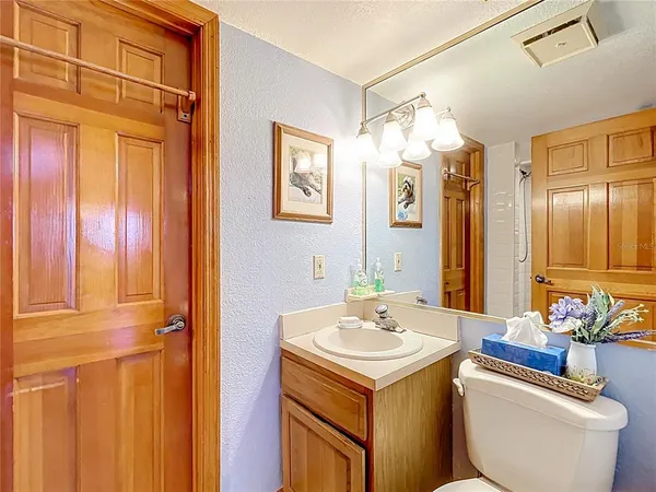 a view of an empty room with cabinet and a window