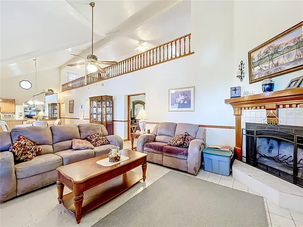 a living room with furniture a table and a chandelier