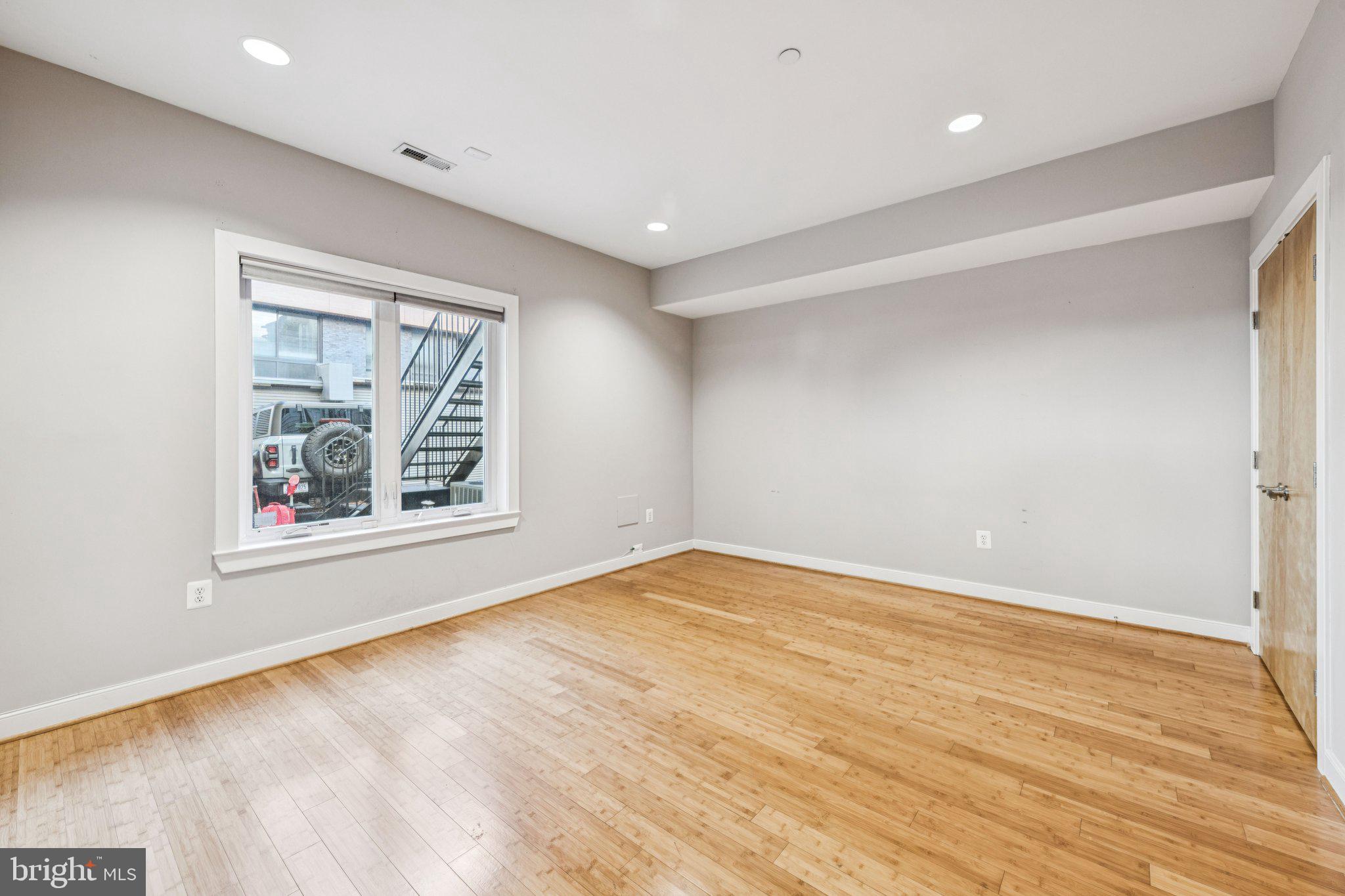241 R Street Northeast, Unit A Washington, DC 20002 - Photo 13 of 33 a view of empty room with window and wooden floor