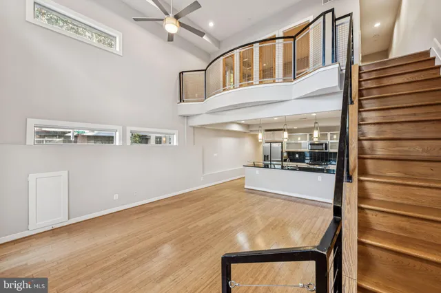 a room with view of kitchen and wooden floor