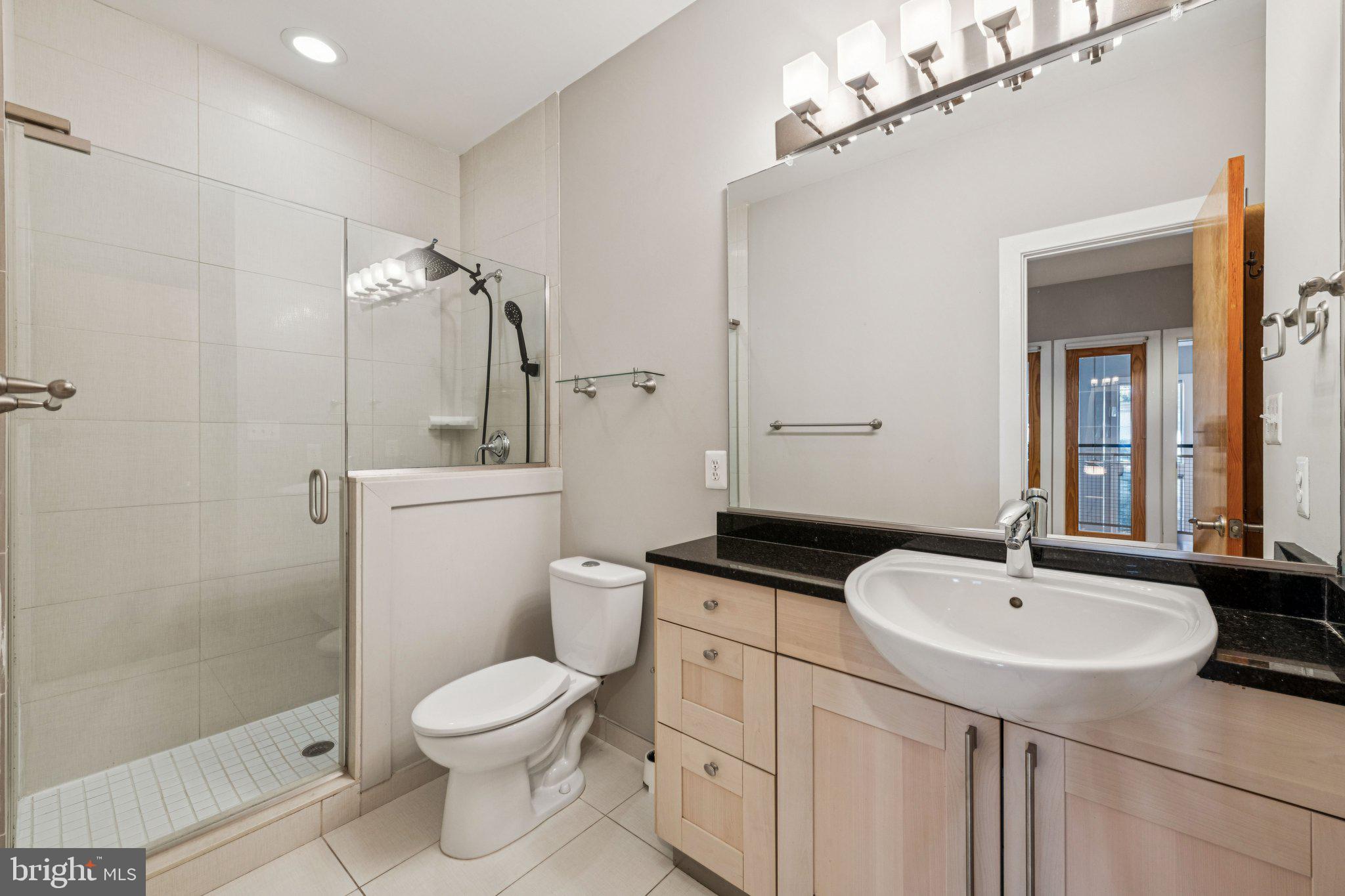 241 R Street Northeast, Unit A Washington, DC 20002 - Photo 22 of 33 a bathroom with a sink a toilet and shower