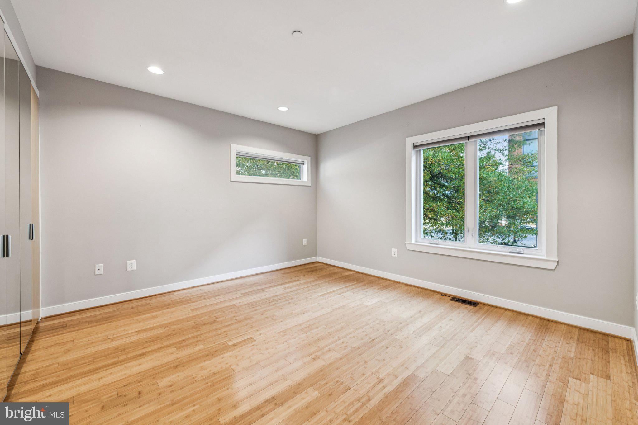 241 R Street Northeast, Unit A Washington, DC 20002 - Photo 23 of 33 a view of an empty room with wooden floor and a window