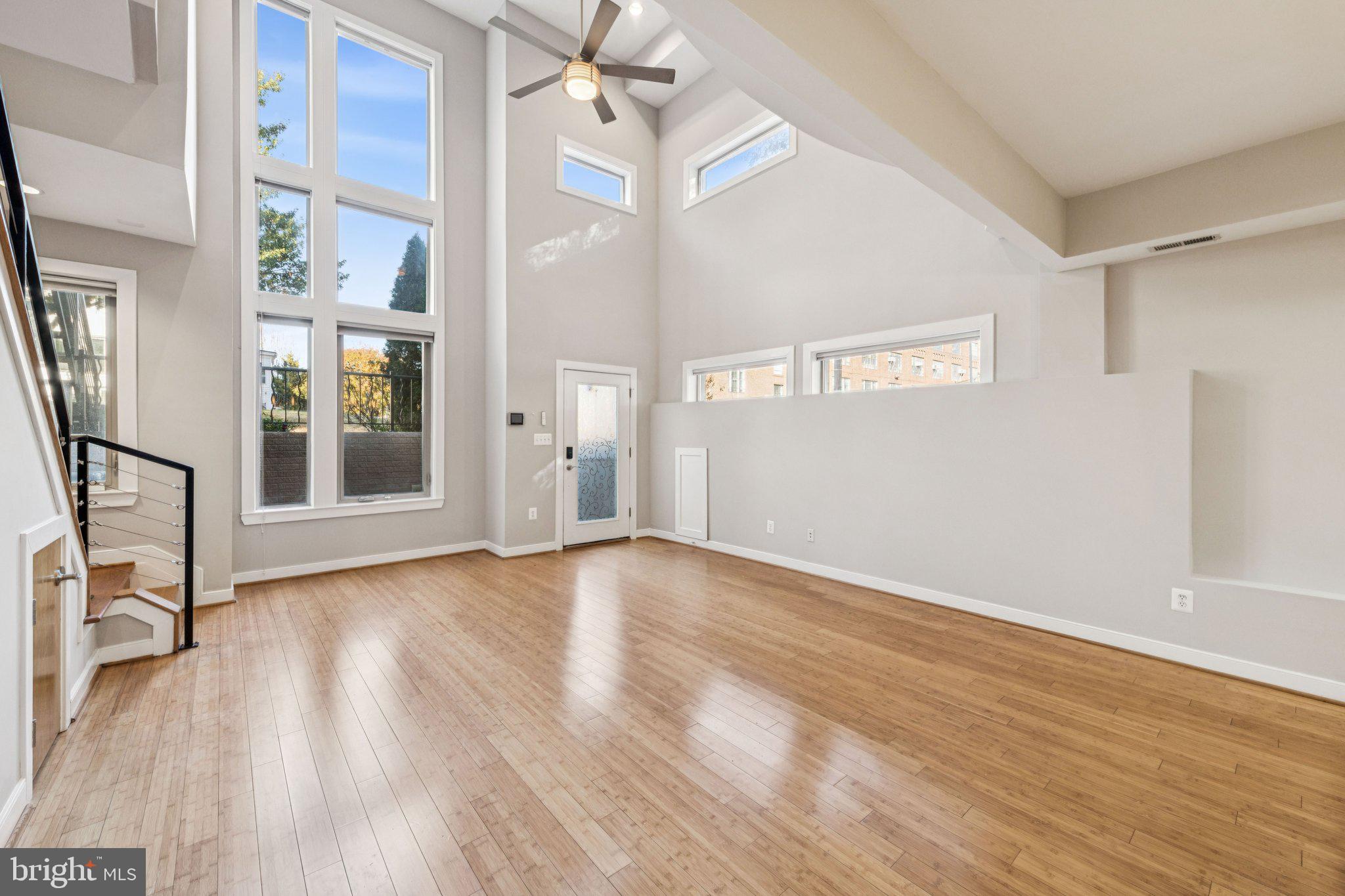 241 R Street Northeast, Unit A Washington, DC 20002 - Photo 6 of 33 a view of an empty room with wooden floor and a window