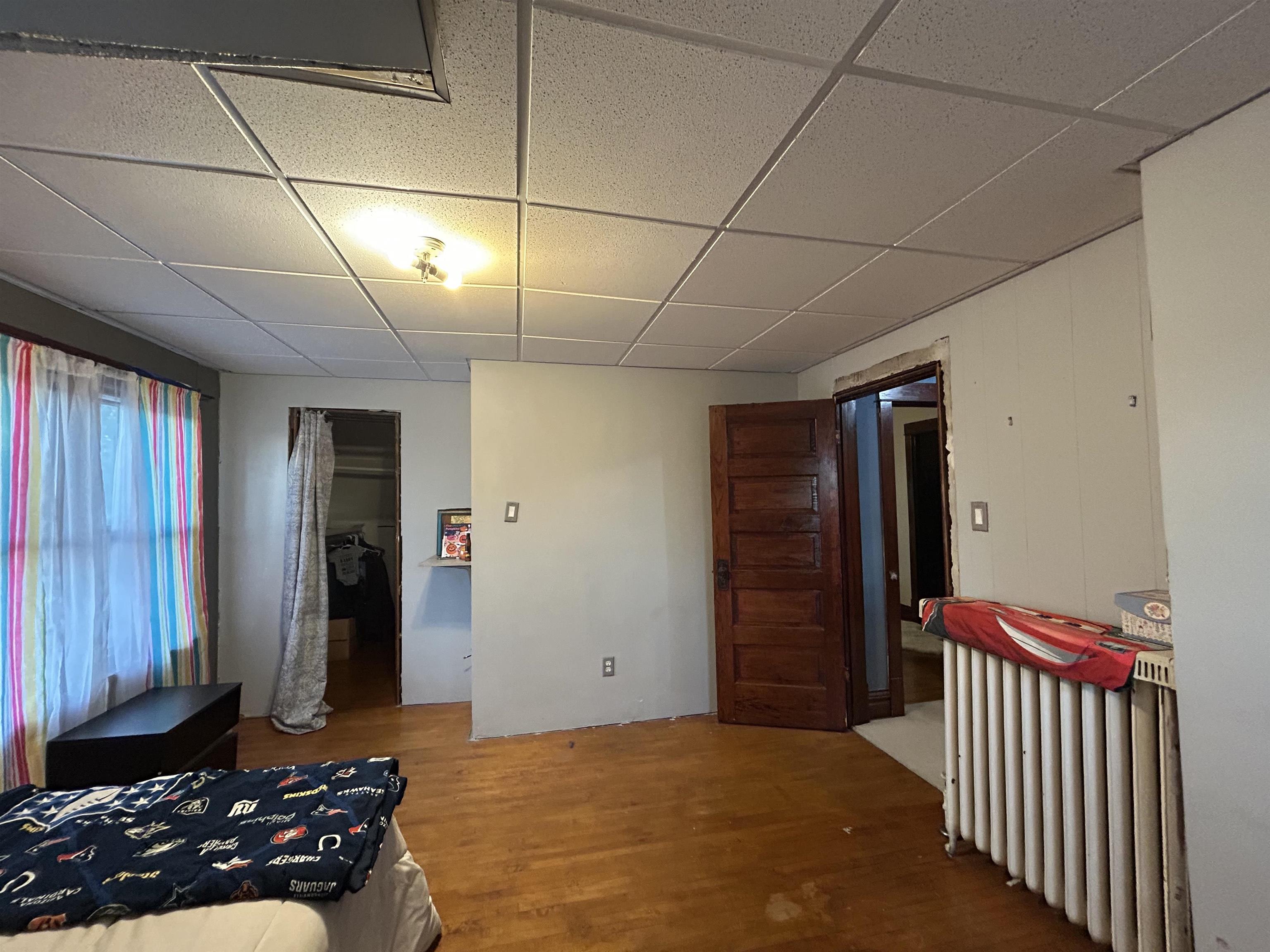 910 North 20th Street Superior, WI 54880 - Photo 16 of 39 Bedroom featuring wood finished floors and a paneled ceiling