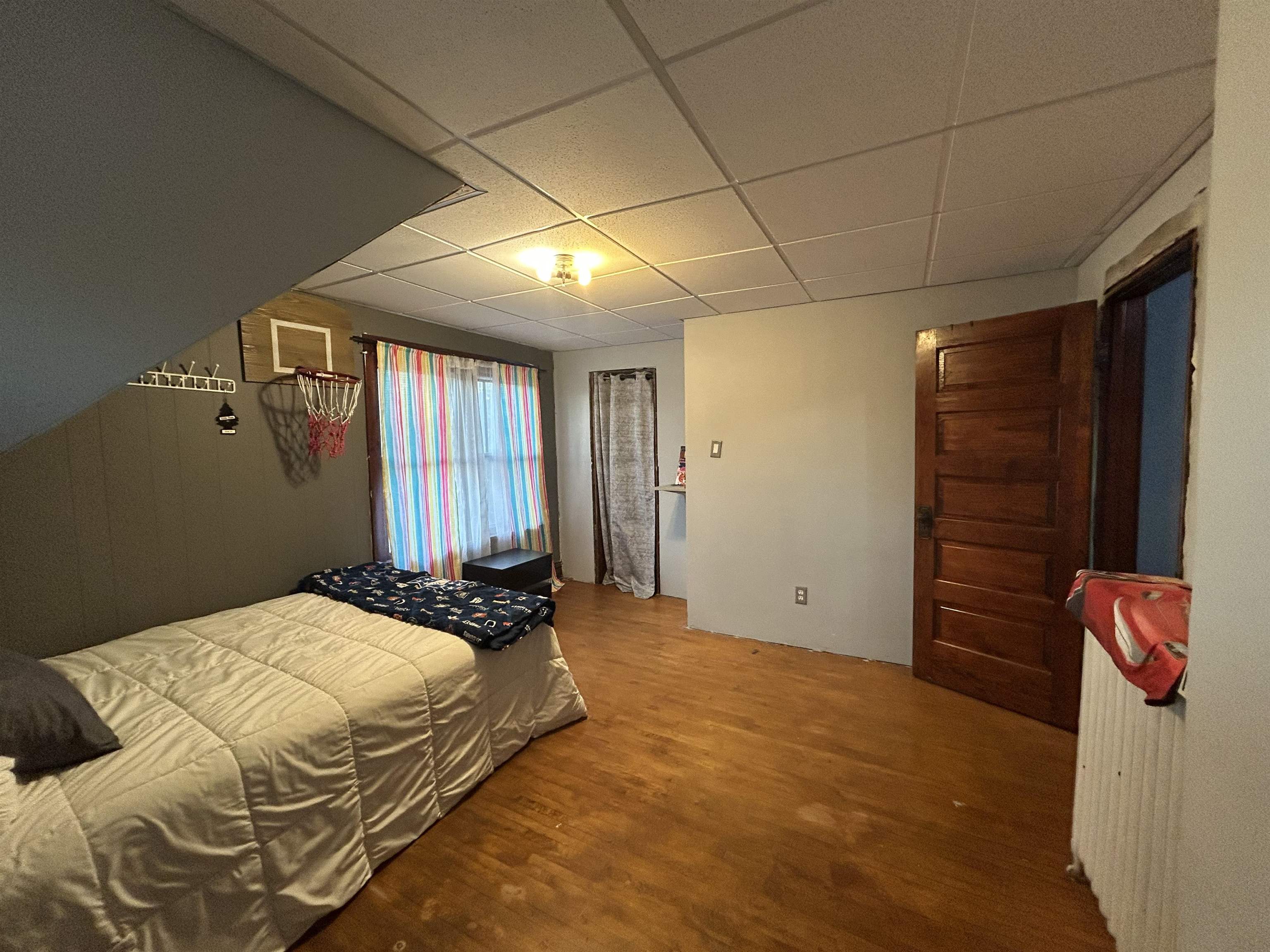 910 North 20th Street Superior, WI 54880 - Photo 20 of 39 Bedroom featuring wood finished floors and a paneled ceiling