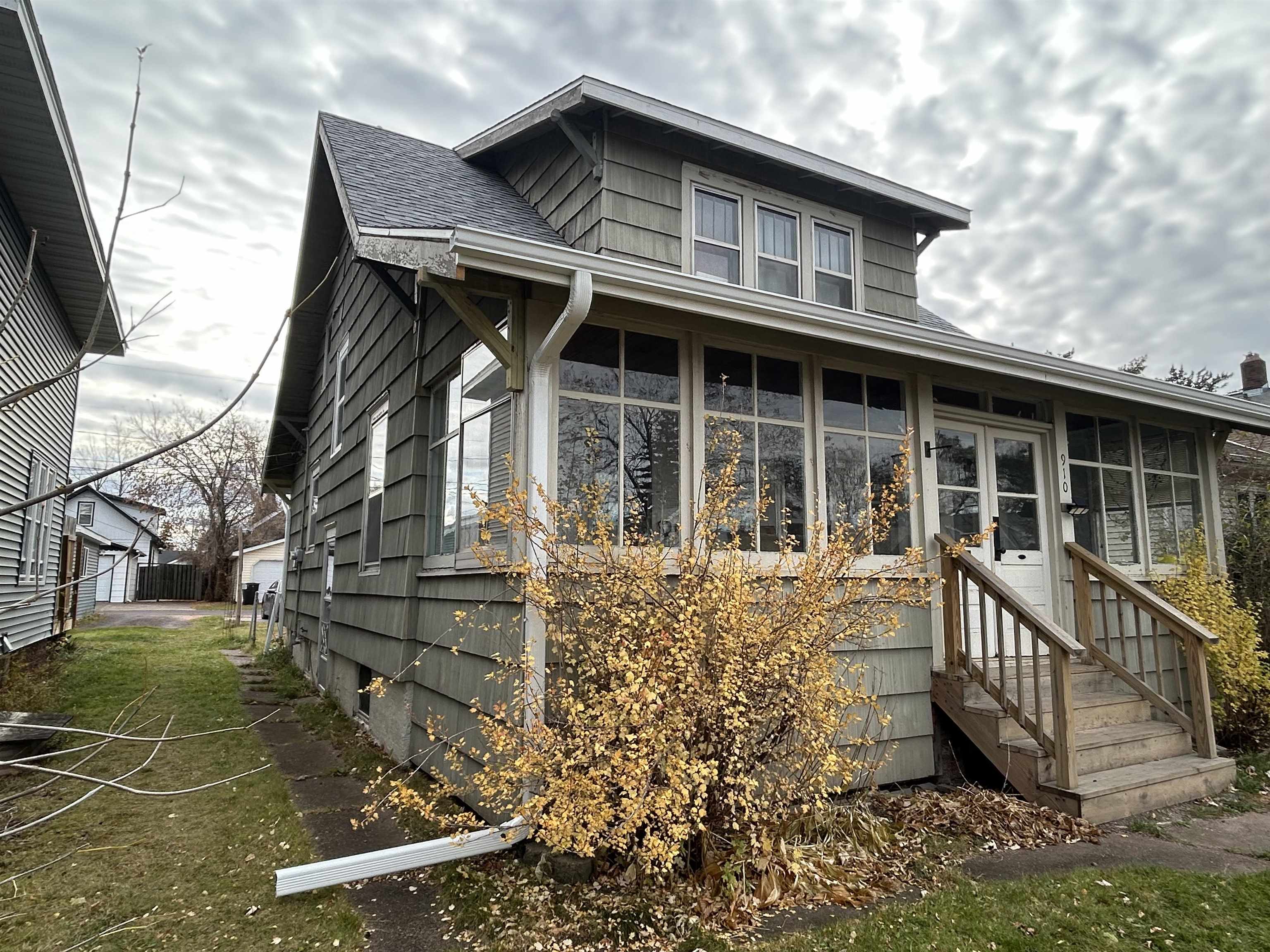 910 North 20th Street Superior, WI 54880 - Photo 2 of 39 View of front of house featuring a sunroom and roof with shingles