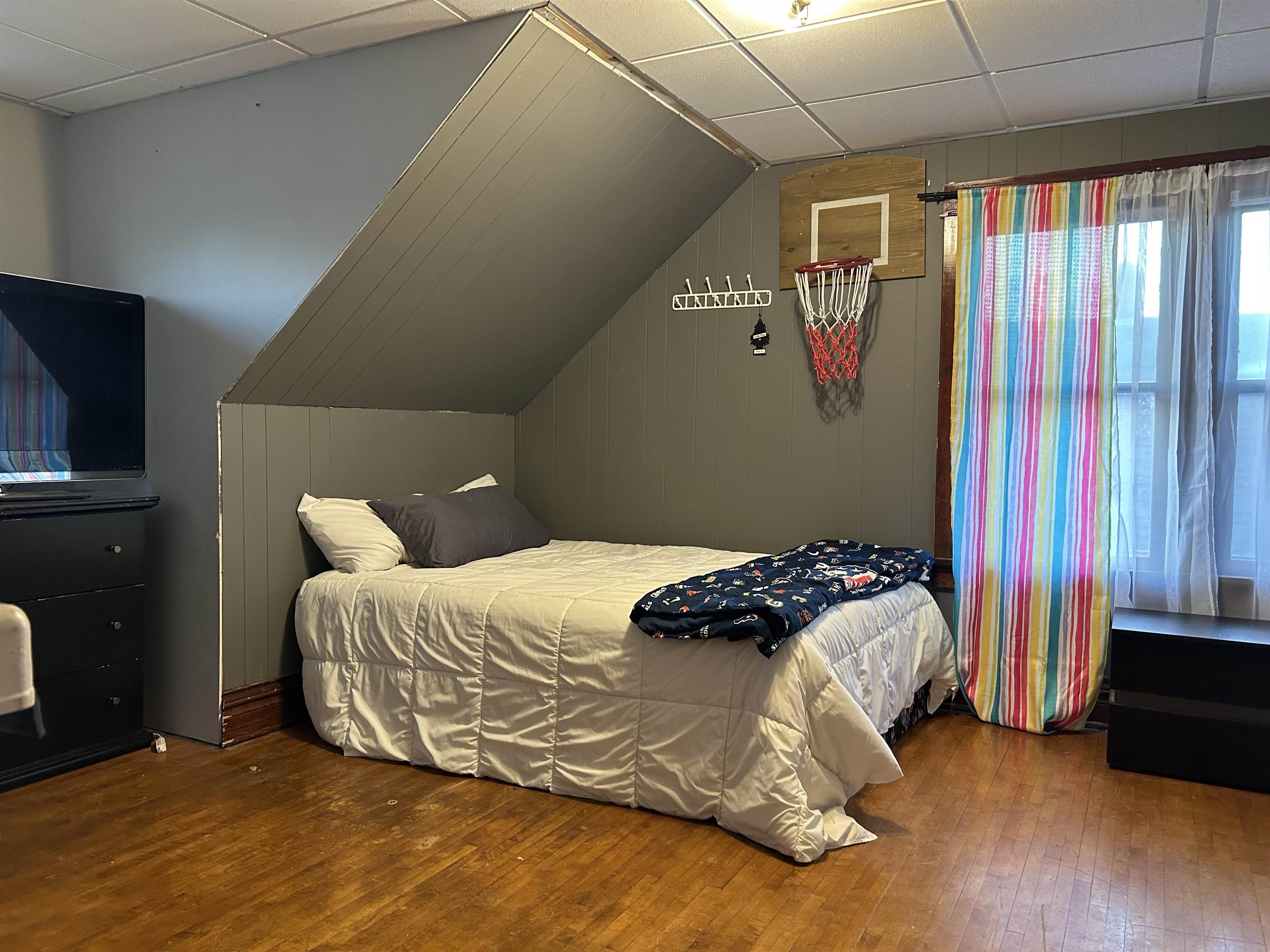 910 North 20th Street Superior, WI 54880 - Photo 21 of 39 Bedroom with a drop ceiling, wood-type flooring, and wooden walls