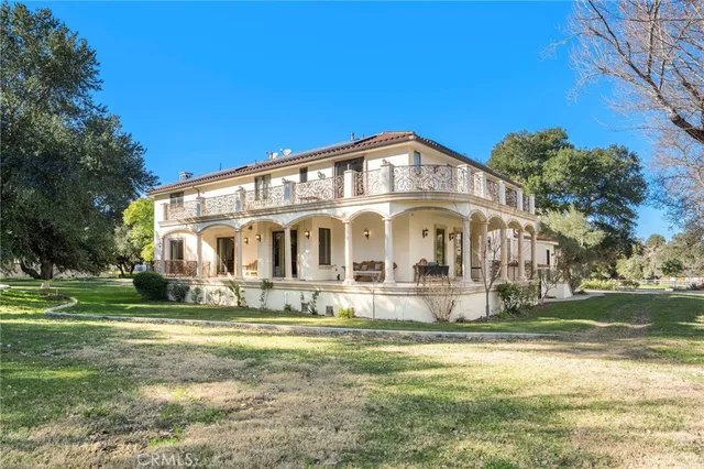a view of a big house with a big yard