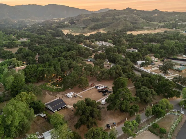 an aerial view of residential house with green space
