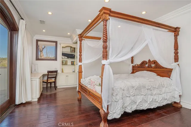a bedroom with bed and wooden floor