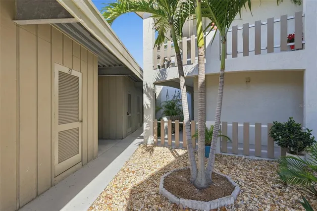 a vase of flowers sitting on a table in front of a building