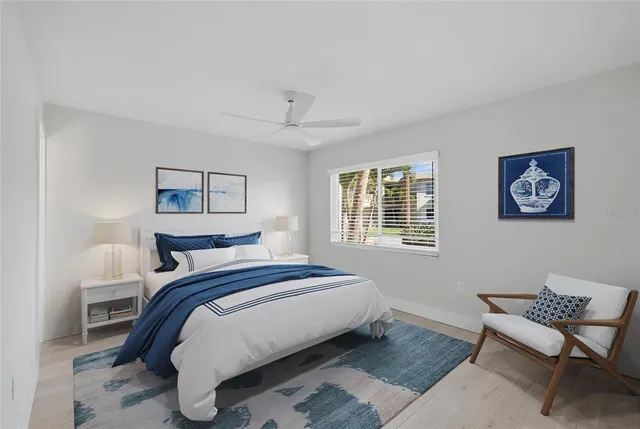 a bedroom with a bed a chair and window