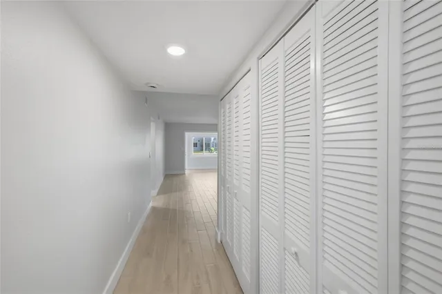a view of a hallway with wooden floor