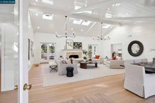 a kitchen with stainless steel appliances granite countertop a lot of cabinets and wooden floor