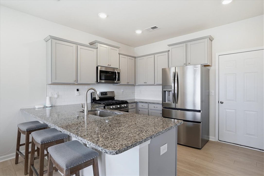 365 Sliding Rock Drive Pendleton, SC 29670 - Photo 11 of 46 A well-appointed kitchen showcasing elegant granite countertops and modern stainless steel appliances.