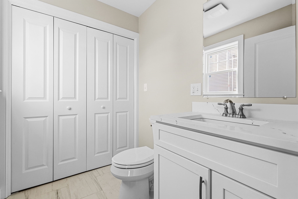 1001 Bay Street Fall River, MA 02724 - Photo 14 of 37 a bathroom with a sink a toilet and a window