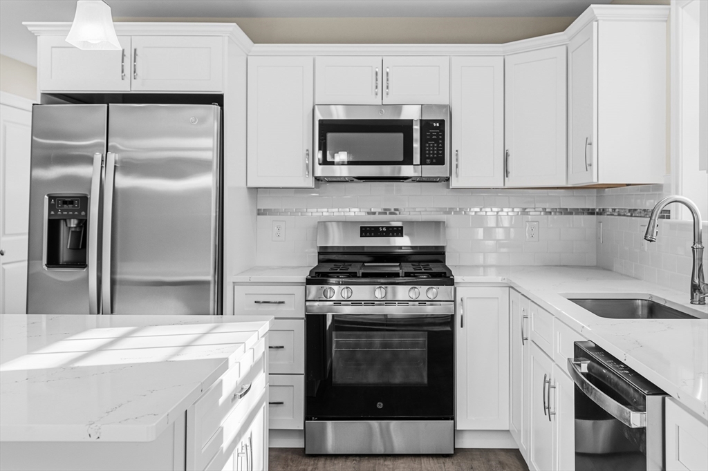 1001 Bay Street Fall River, MA 02724 - Photo 4 of 37 a kitchen with cabinets stainless steel appliances and a sink