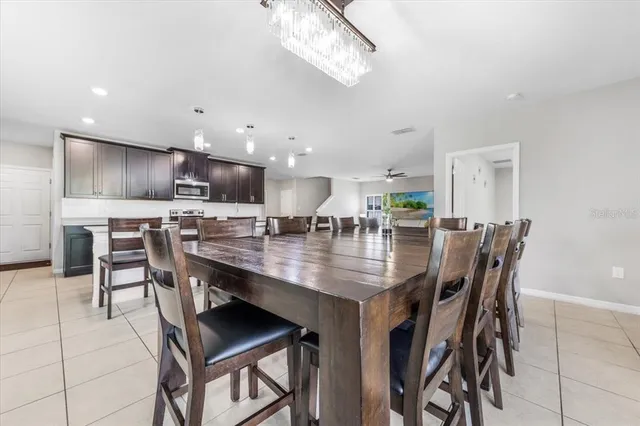 a kitchen with metallic refrigerator and cabinets