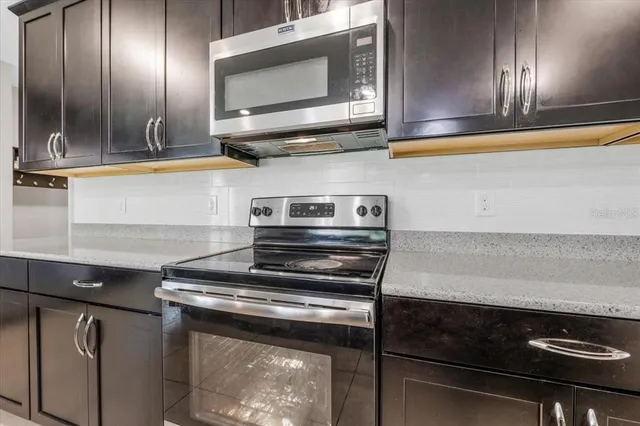 a kitchen with stainless steel appliances lots of counter top space