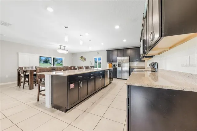 a kitchen with stainless steel appliances granite countertop a sink and dishwasher with wooden floor