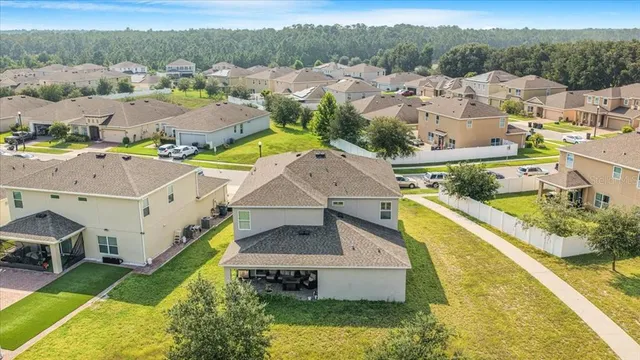 an aerial view of residential houses with yard