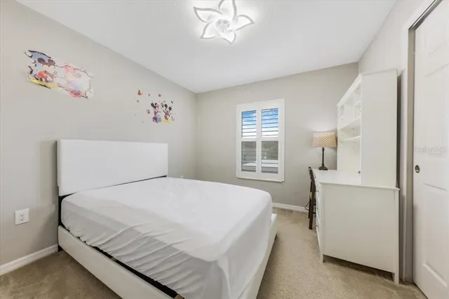 a bed room with furniture and a lamp