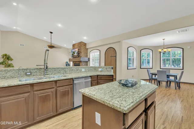 a living room with furniture a window and wooden floor