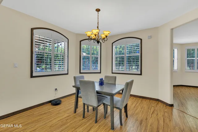 a spacious bathroom with a granite countertop sink a toilet a mirror and vanity