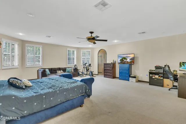 a bedroom with a bed and a chandelier