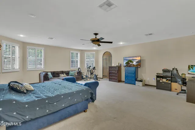 an aerial view of a house with swimming pool and large trees