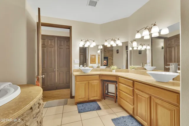 an aerial view of a house with a yard and large trees