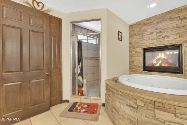 a view of a patio with a table and chairs under an umbrella