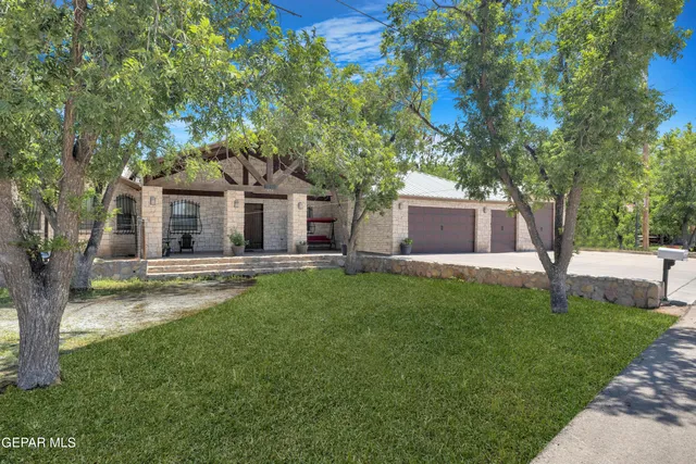 a front view of house with yard and green space