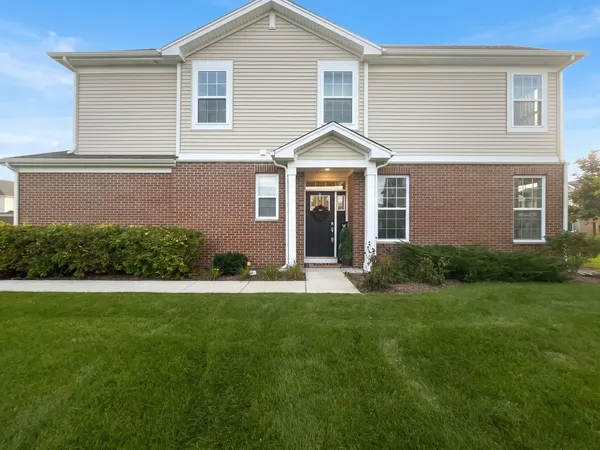 a front view of a house with a yard