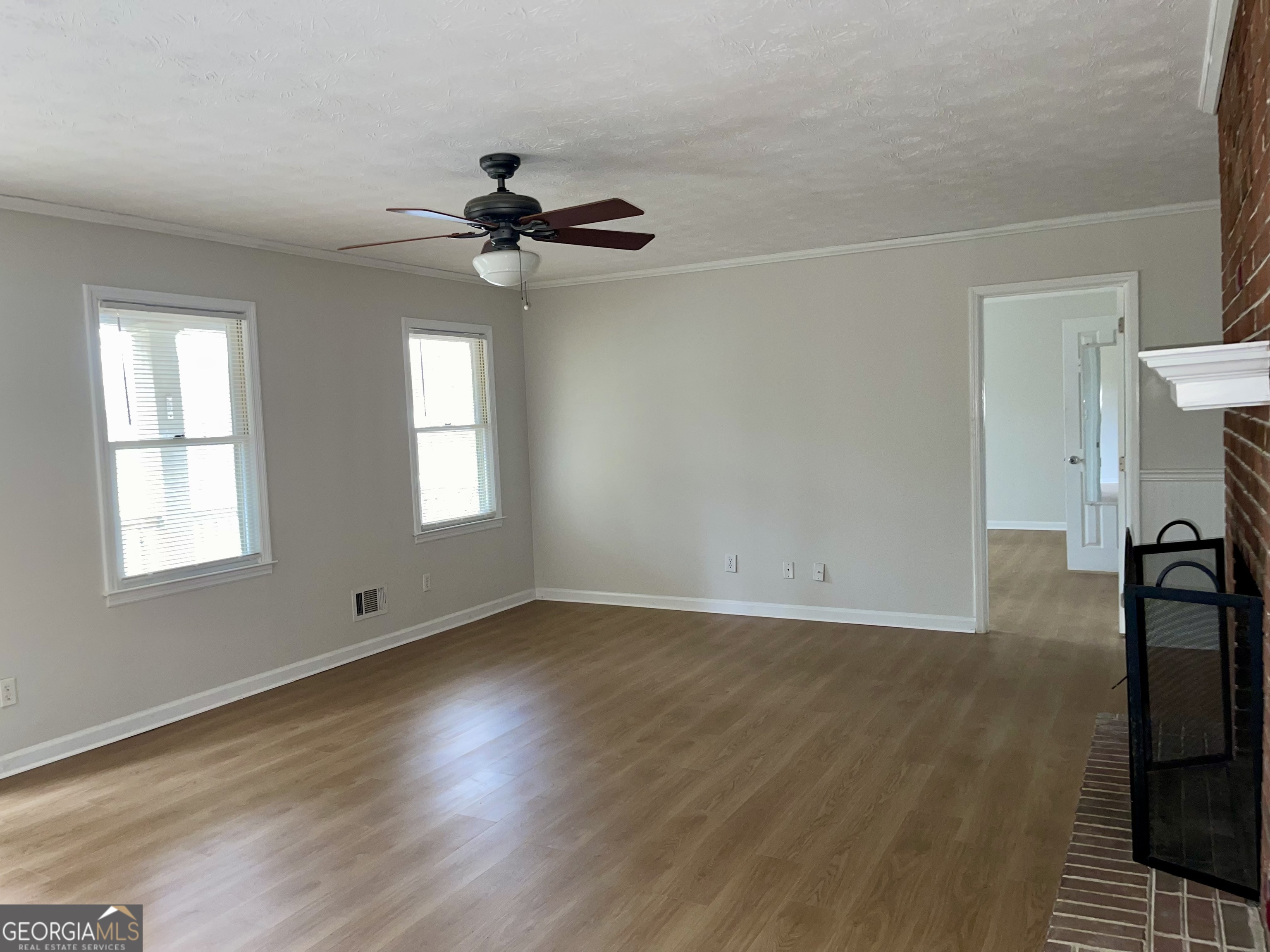 764 Hemphill Road Stockbridge, GA 30281 - Photo 2 of 14 a view of empty room with wooden floor and fan