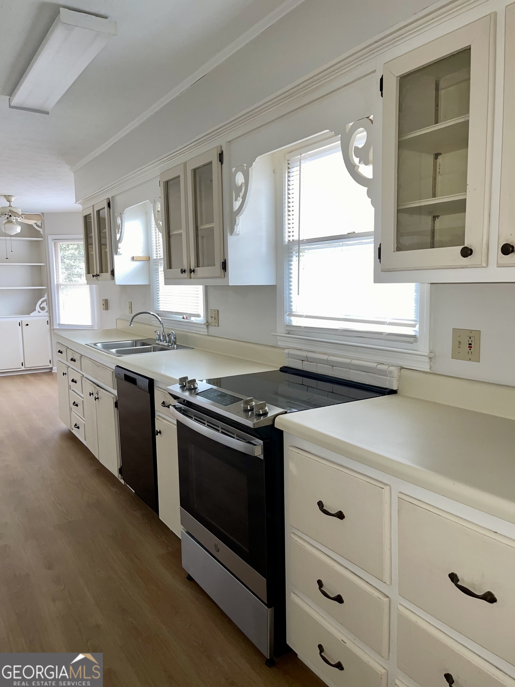 764 Hemphill Road Stockbridge, GA 30281 - Photo 6 of 14 a kitchen with stainless steel appliances white cabinets and a sink