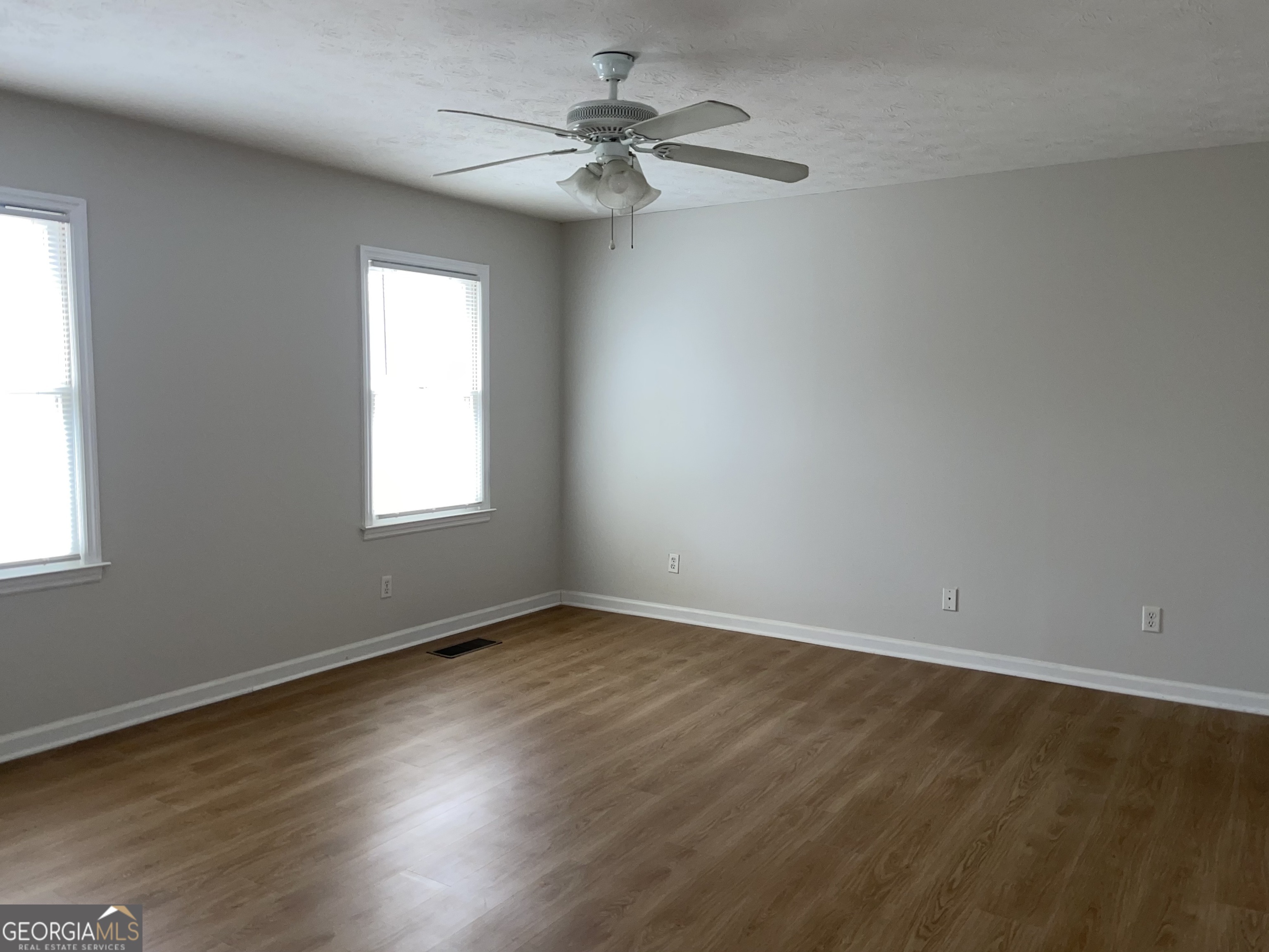 764 Hemphill Road Stockbridge, GA 30281 - Photo 7 of 14 a view of an empty room with wooden floor and a window