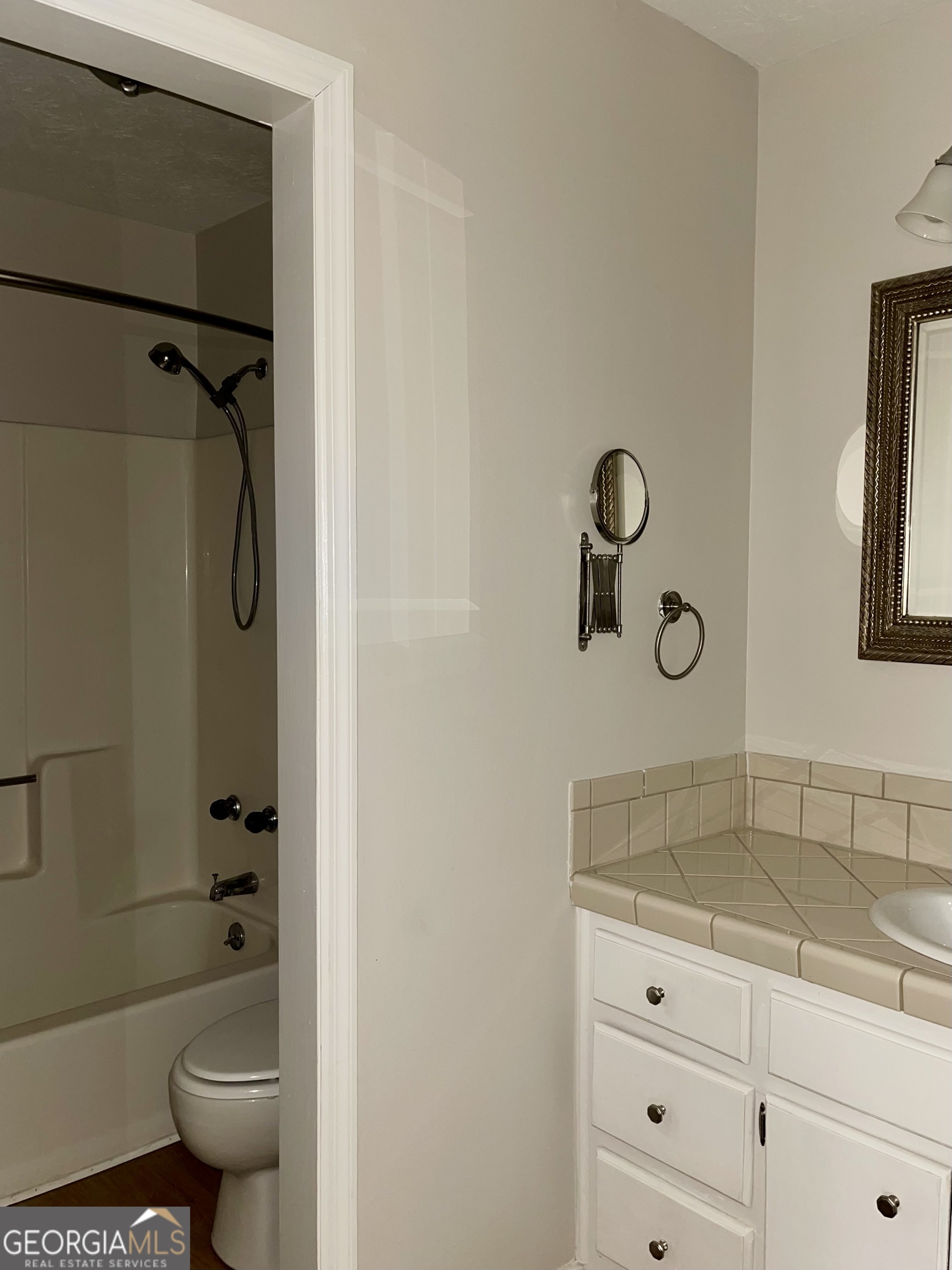 764 Hemphill Road Stockbridge, GA 30281 - Photo 8 of 14 a bathroom with a granite countertop sink a toilet and shower