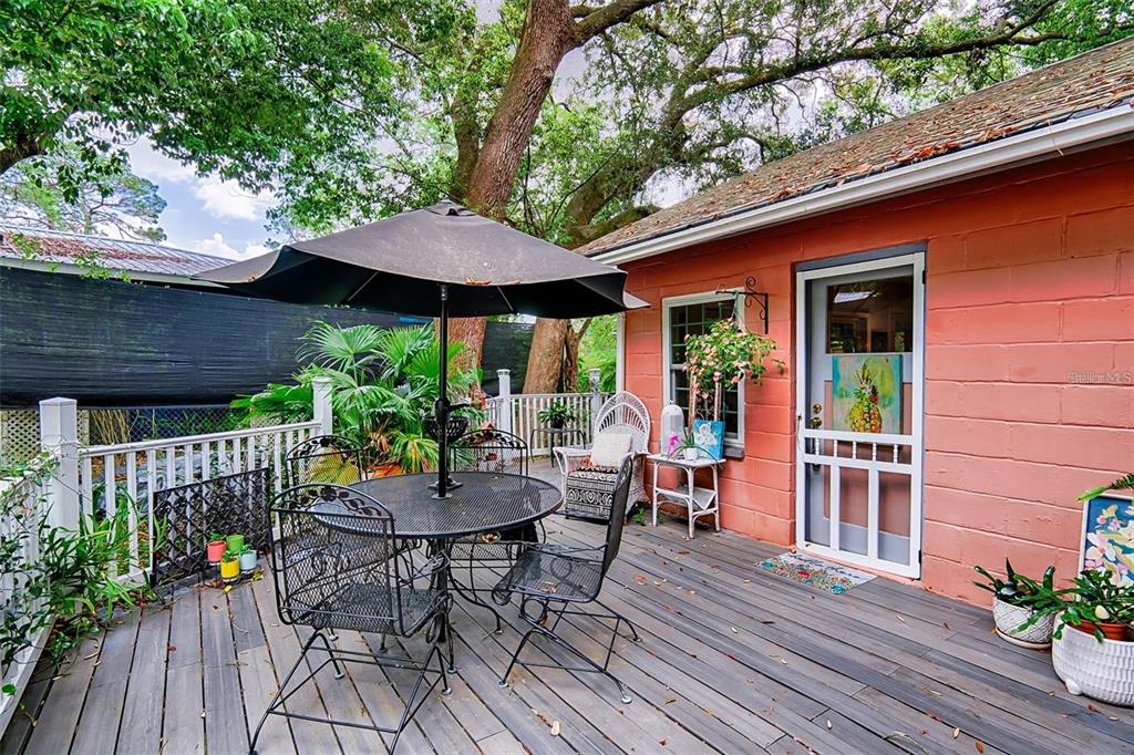 360 Southeast Lakeview Drive Keystone Heights, FL 32656 - Photo 14 of 17 a view of patio with table and chairs potted plants and floor to ceiling window and wooden floor