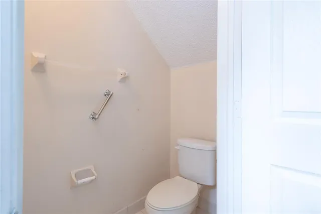 a white toilet sitting next to a shower