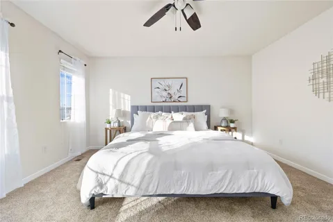 a bedroom with a bed and painting on the wall
