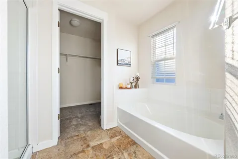 a white bath tub sitting next to a window