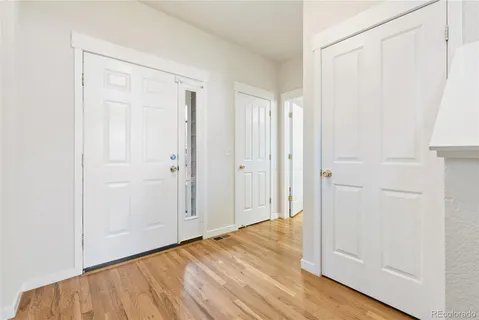 an empty room with wooden floor