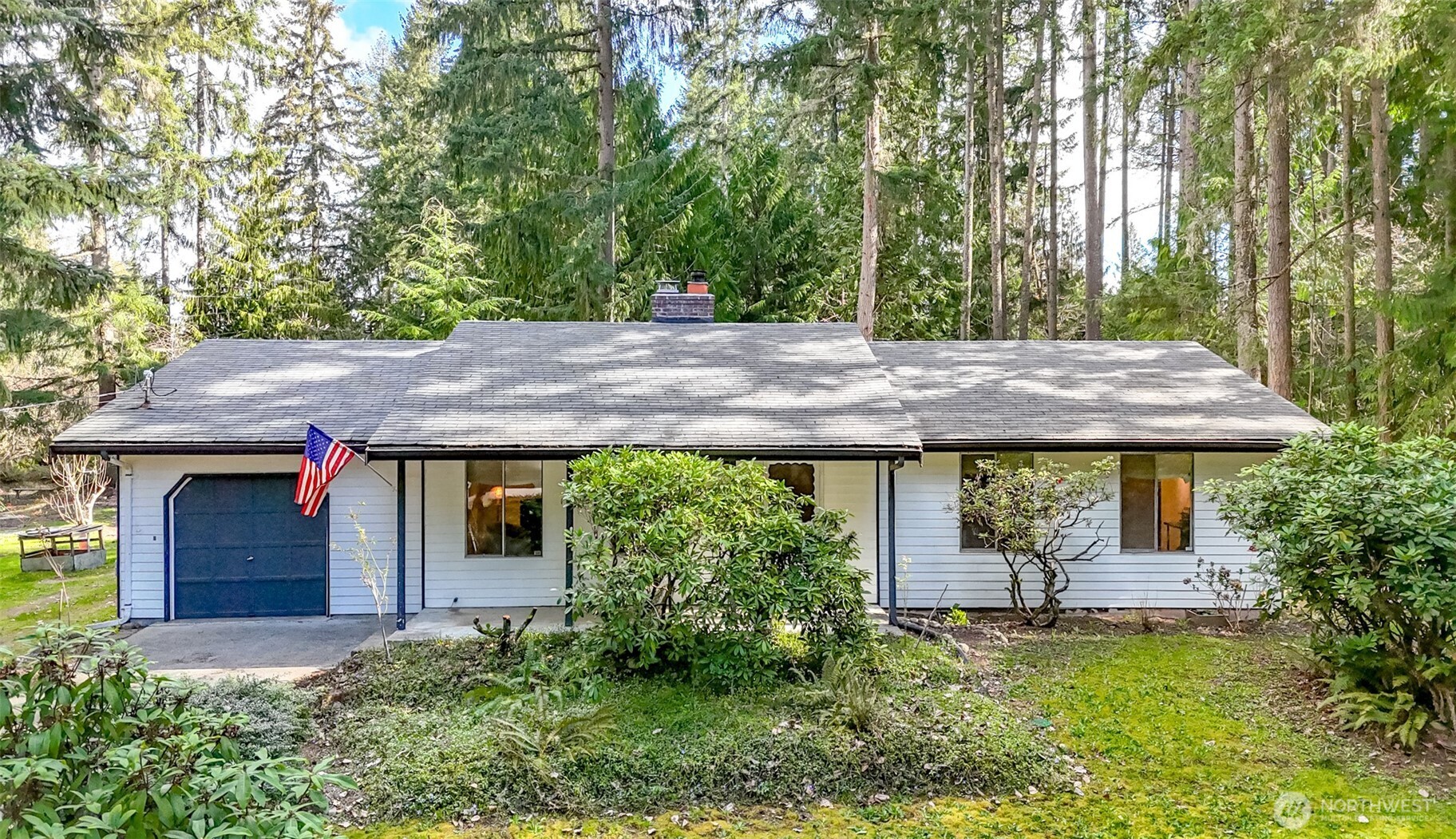 4701 292nd Street East Graham, WA 98338 - Photo 1 of 40 a front view of a house with garden