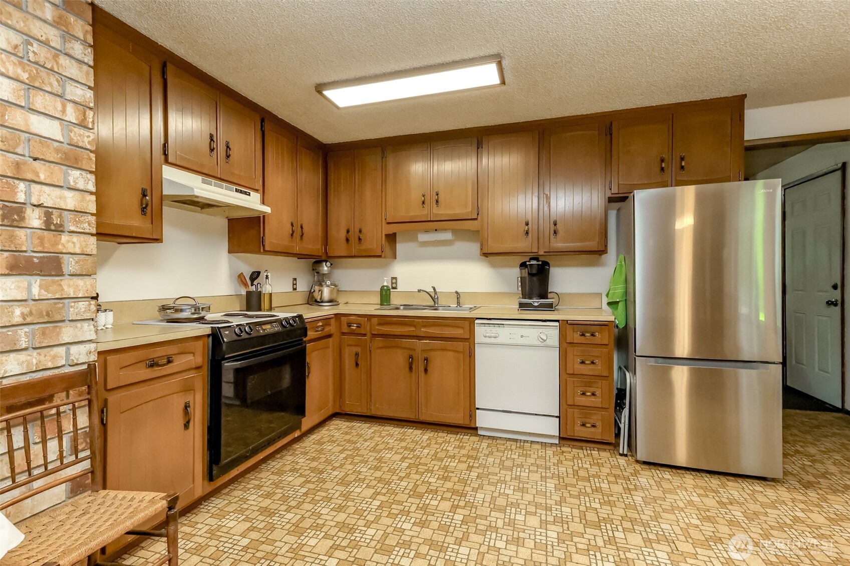 4701 292nd Street East Graham, WA 98338 - Photo 11 of 40 a kitchen with a refrigerator sink and stove