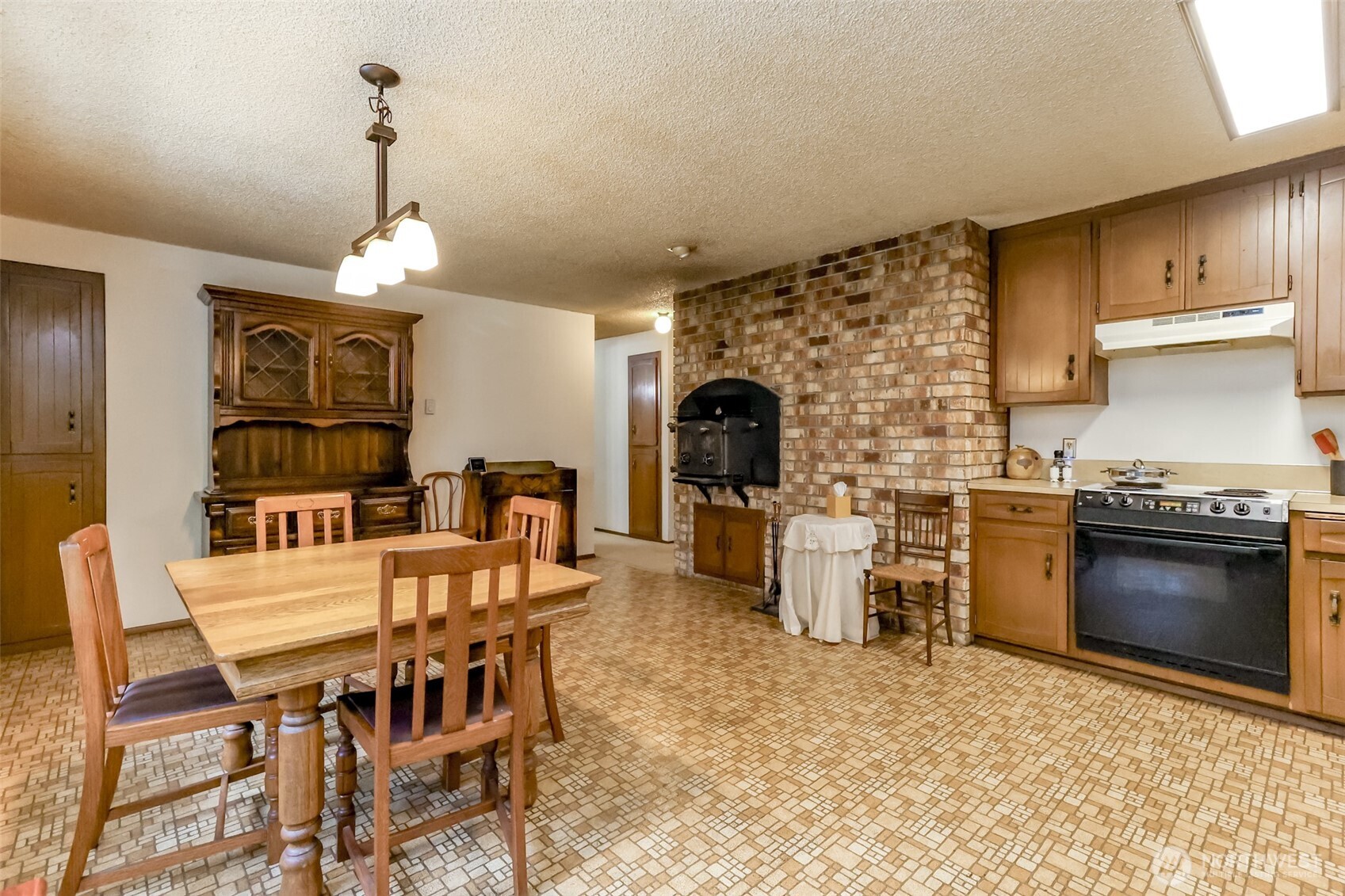 4701 292nd Street East Graham, WA 98338 - Photo 13 of 40 a kitchen with a stove and a refrigerator