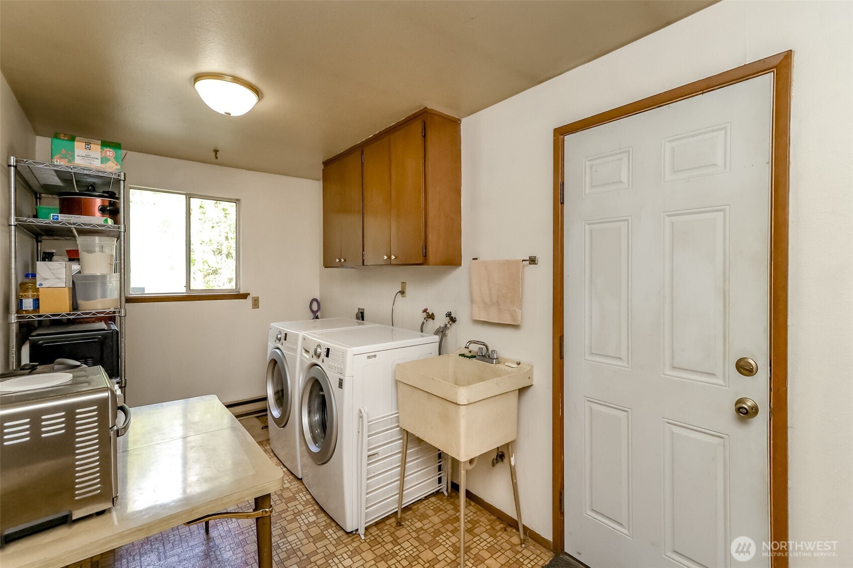 4701 292nd Street East Graham, WA 98338 - Photo 16 of 40 a utility room with cabinets dryer and washer