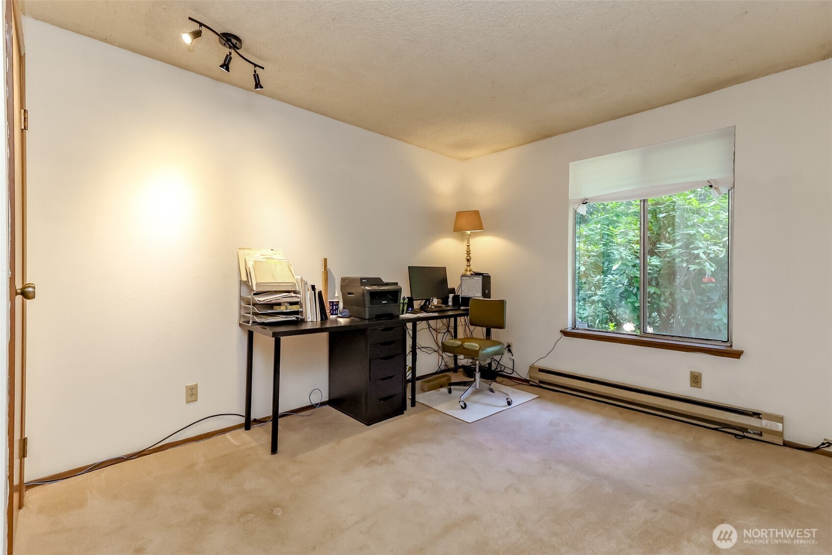 4701 292nd Street East Graham, WA 98338 - Photo 19 of 40 a view of a workspace with furniture and a window