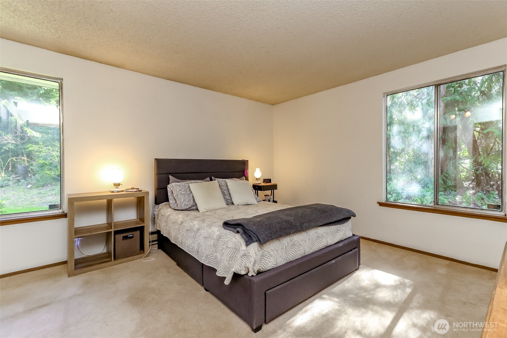 4701 292nd Street East Graham, WA 98338 - Photo 21 of 40 a bed sitting in a bedroom next to a window