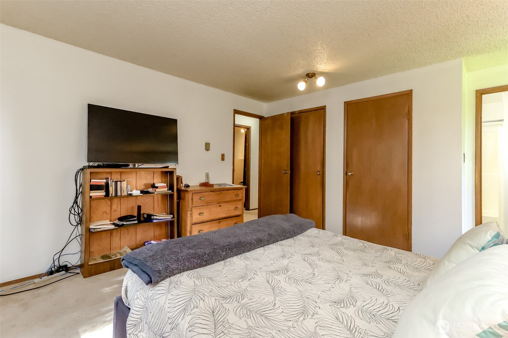 4701 292nd Street East Graham, WA 98338 - Photo 23 of 40 a bedroom with a bed and a flat screen tv